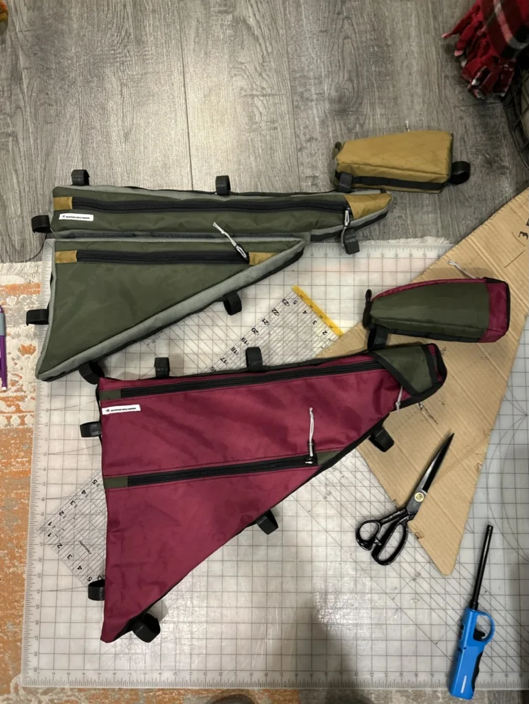 Custom frame bags laid out on a work surface during construction
