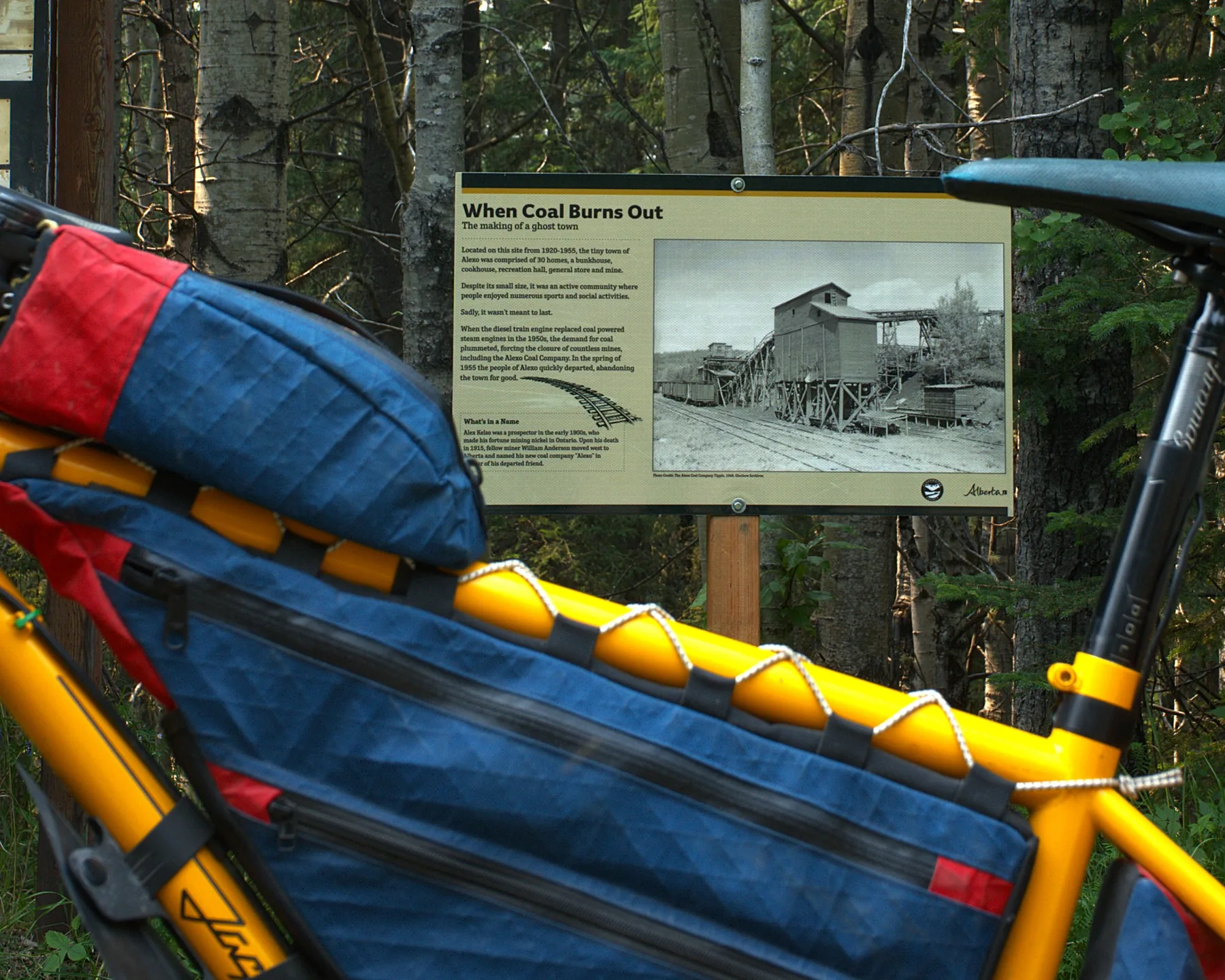 Bikepacking bike beside Alberta heritage signage