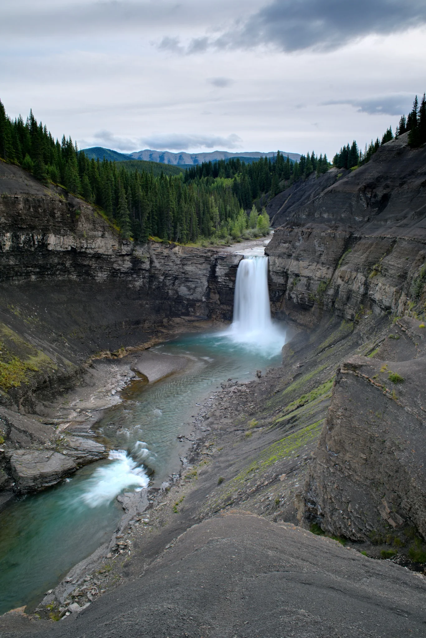 Ram Falls dropping into a deep forested canyon in Alberta
