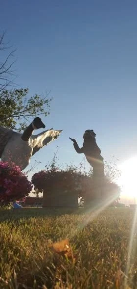 Rider posing with the Hanna goose landmark at sunset