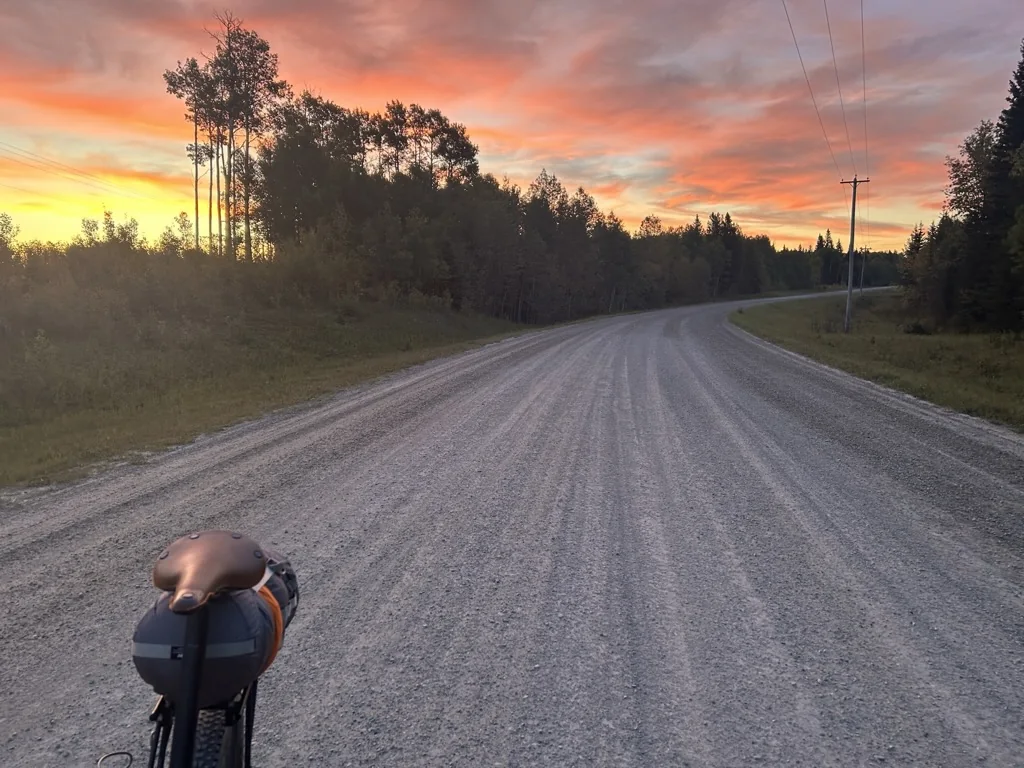 Loaded bike on a quiet Alberta road through working country